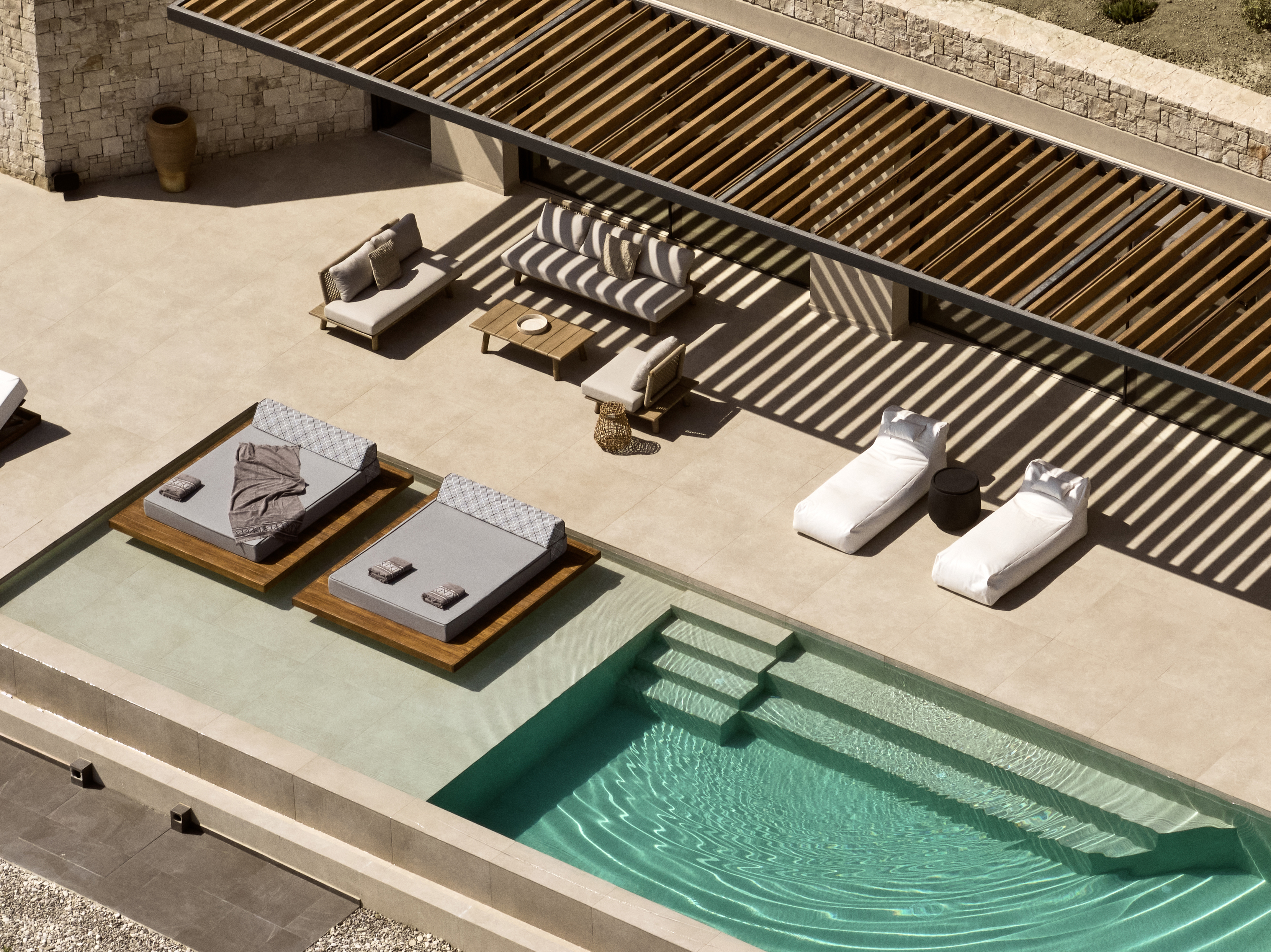 Bird's eye view from the villa outdoor pool settings, featuring swim up sun-beds for the ultimate summer experience.