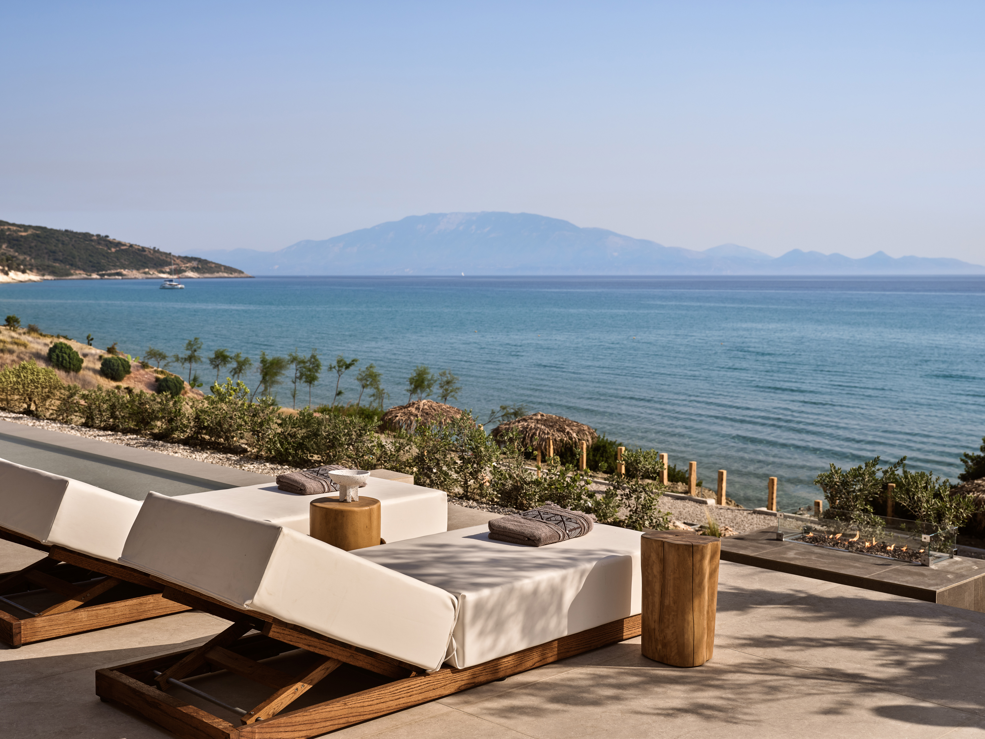 Premium sun-beds are featured and a fire pit.